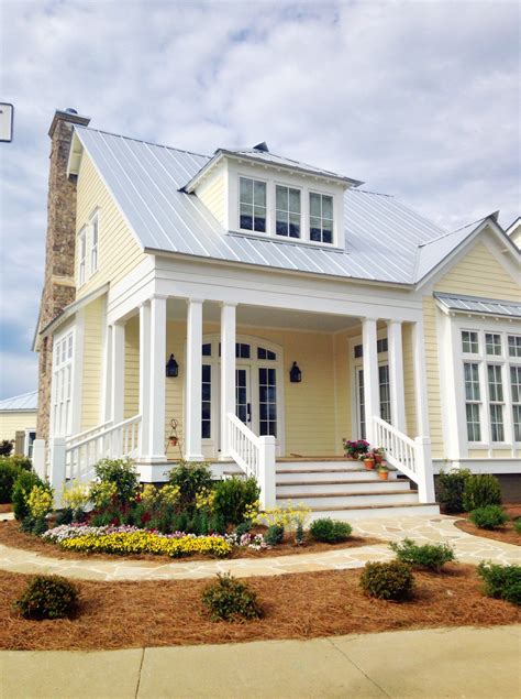 yellow hardie board houses with metal roof|yellow house with metal roof.